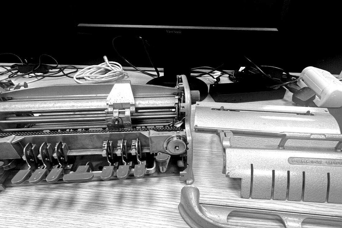 Perkins Brailler mechanism being repaired and adjusted